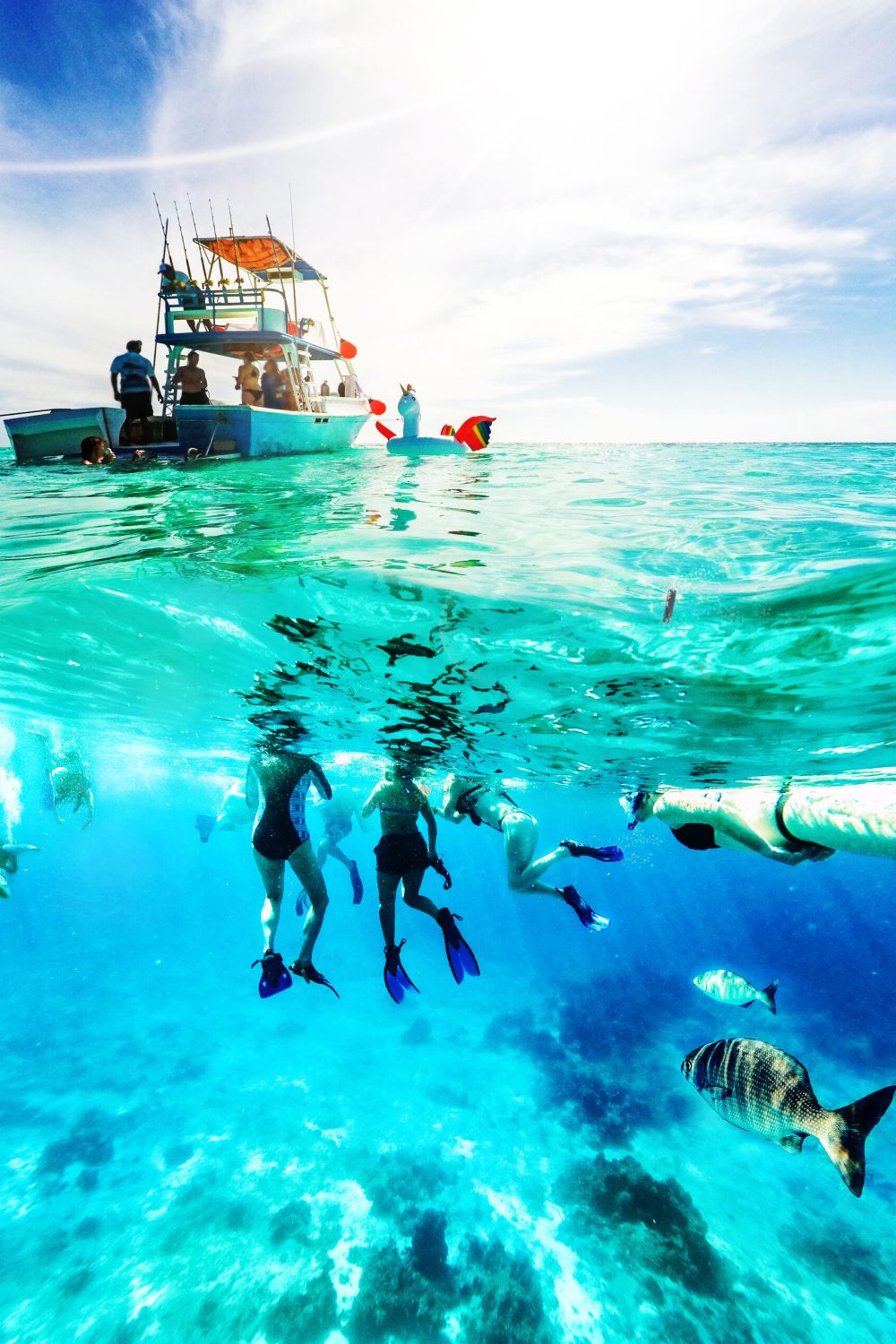 Group of friends on a Carribean Sea adventure with party boat, snorkeling and scuba diving